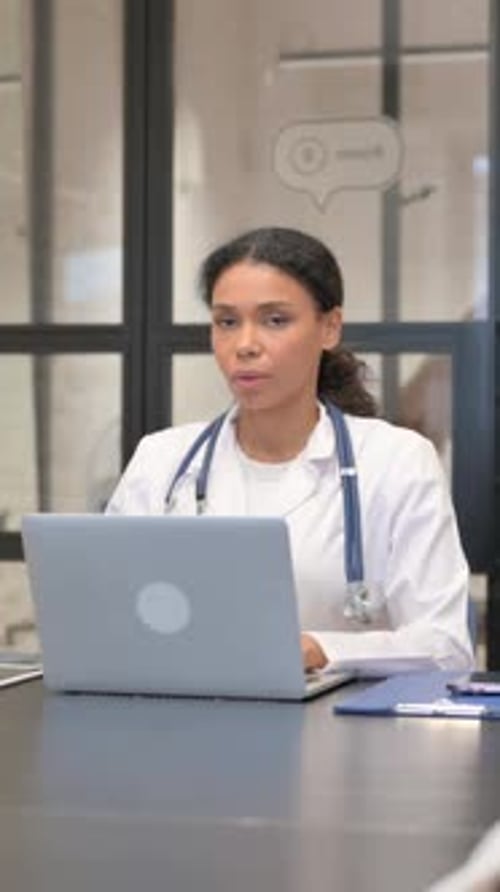African Female Doctor Looking at Camera in Hospital, vertical video