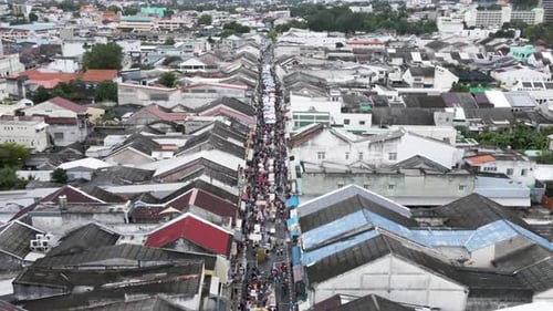 Busy market street in Phuket Old Town, Thailand, seen from above on a cloudy day