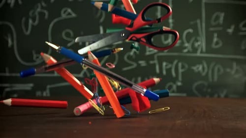 Various School Tools Fall on the Desk Filmed on a Highspeed Camera at 1000 Fps