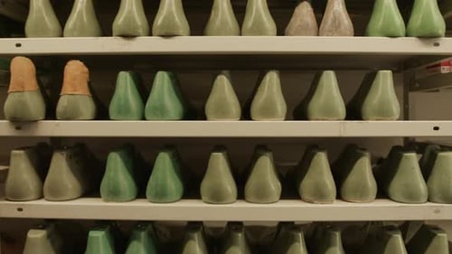 Shoe Lasts and Boots on Shelves in Shoemaking Workshop