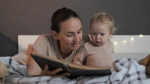 Mother and Baby Reading Book at Bedtime