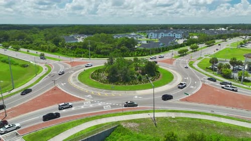 Aerial View of Road Roundabout Intersection with Fast Moving Heavy Traffic