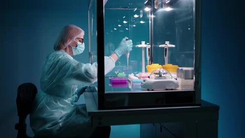 Female Scientist Working in Transparent Lab Enclosure