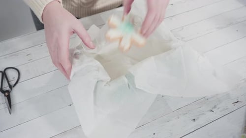 Packing Decorated Holiday Cookies into Gift Box