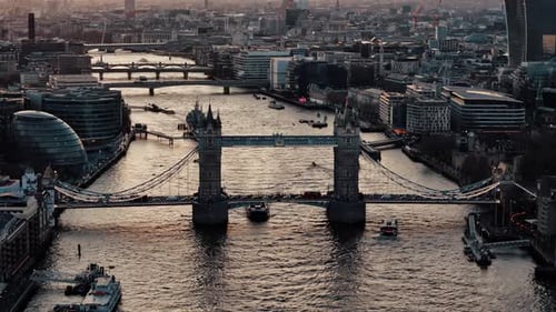 Sundown Serenity: Aerial View of Tower Bridge Amidst London's River Traffic