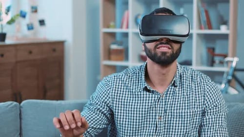 Man Experiencing Virtual Reality on Couch at Home