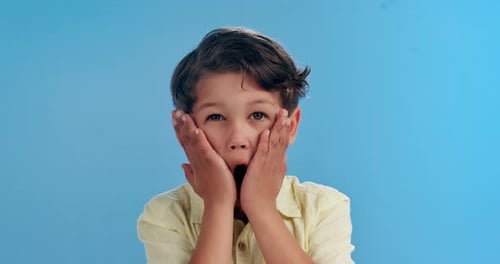 Scream, surprise and face of child on blue background for news, announcement and information