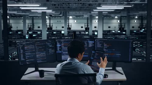 Back View Of Asian Man Developer Working With Tablet While Write Code In Data Center