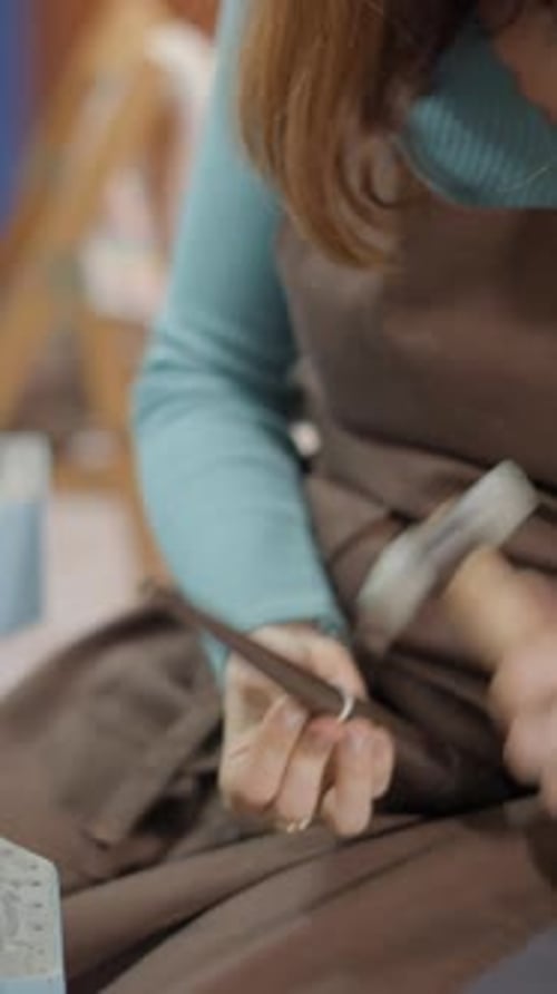 Female Jeweler With A Hammer Strikes On The Silver Billet Of Ring To Make It Round Perfect Close Up