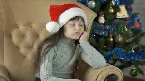 Sad Girl Sitting Next to Christmas Tree