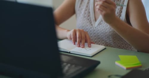 Individual Working From Home Using Laptop and Notebook