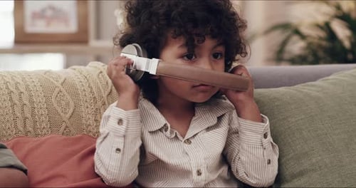 Cute Child Listening to Music with Headphones