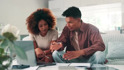 Young Couple Working on Laptop at Home