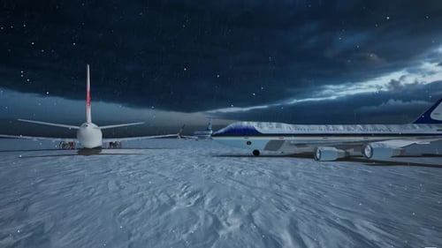 Airplanes On Snowy Tarmac With Falling Snow