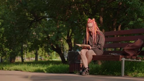 She Reads Peacefully Woman Enjoys Quiet Reading Outdoors Relaxed Woman Immersed in Book on Park