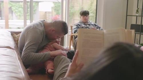 Family Relaxing Together on the Sofa at Home