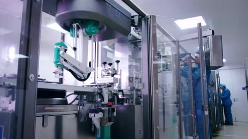 Factory Worker at Industrial Workshop. Operator Setting Packaging Line. Engineer Configuring Packagi