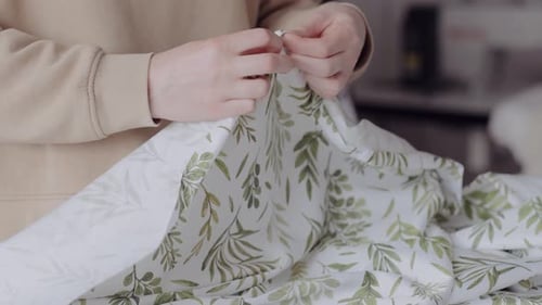 Woman Sews Floral Fabric in Bright Home