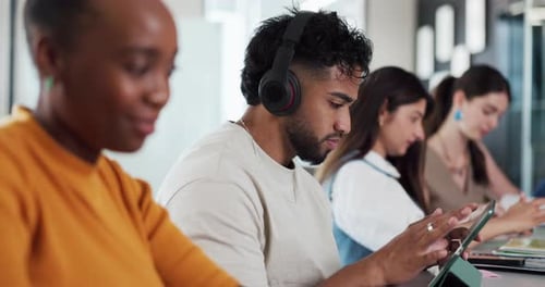 Diverse Group Working with Technology in Modern Office