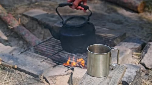 Teapot and Mug by Campfire in the Wilderness