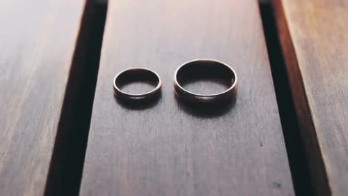 Gold Wedding Rings on Wooden Table Indoors