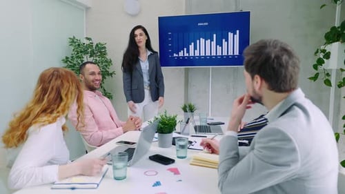 Focused Diverse Colleagues Listening to Young Motivated Skilled Presenter at Office Meeting Smart