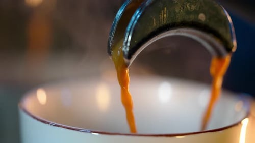 Coffee Espresso Pouring into Ceramic Mug Close Up