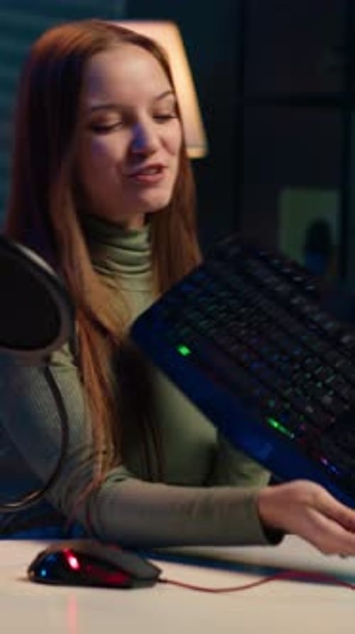 Woman Presents Gaming Keyboard and Mouse at Desk