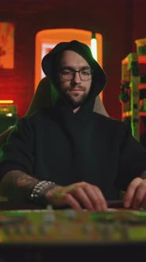 Man with Glasses Typing on Computer at Night