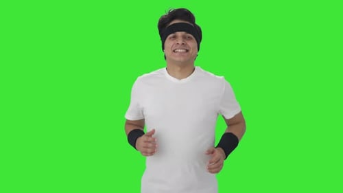 Glücklicher Inder beim Joggen Grüner Bildschirm