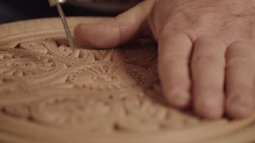 Wood Carver Creating Intricate Details on Wooden Surface