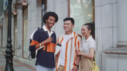 Three Friends Smile on City Street