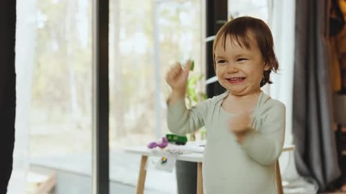 Smiling Child Plays at Home on Bright Day