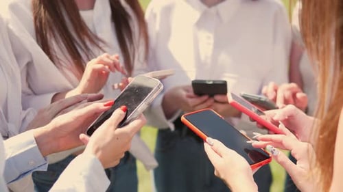 Diverse People Using Smartphones Together in Urban Setting