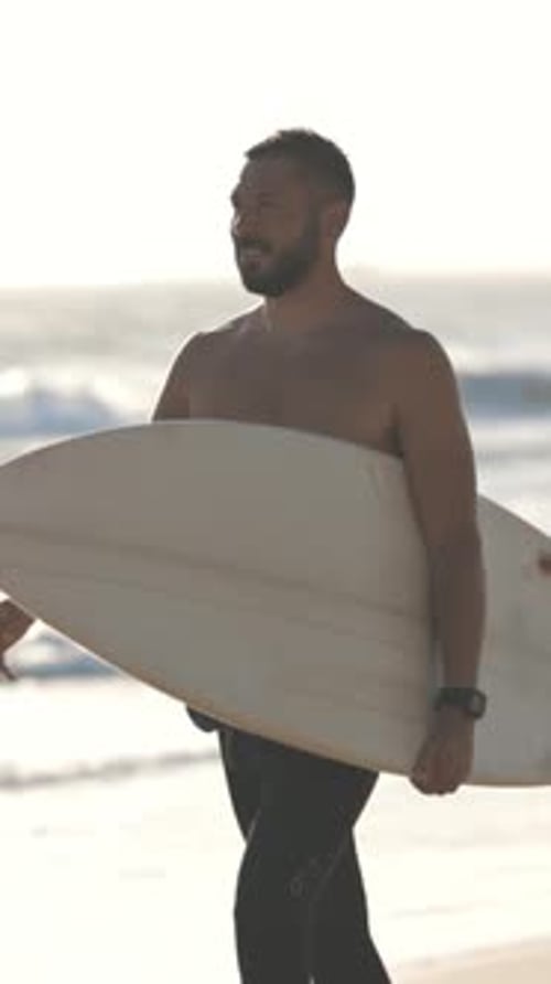 Man Walking with Surfboard on Sunny Beach