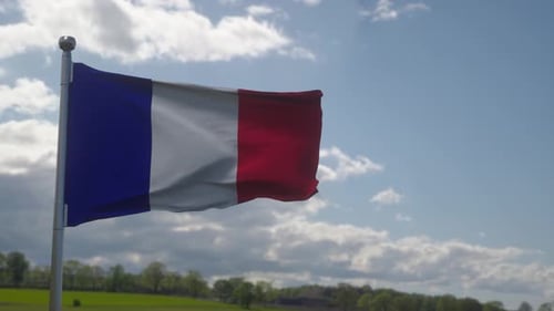 Realistic French Flag Waving Against Blue Sky and Green Field