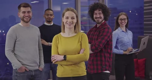 Smiling Team in Modern Office at Night