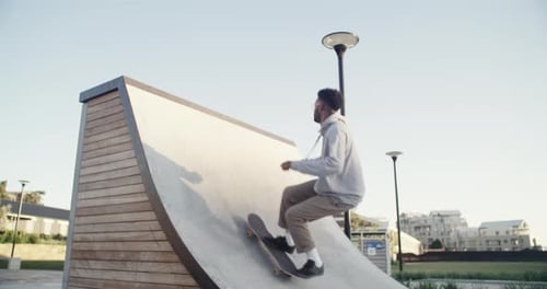 A young man out skating at a skatepark