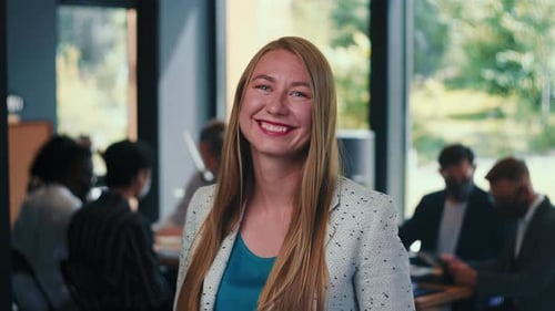Portrait of Beautiful Young 30s Blonde Business Woman Smiling at Camera at Modern Light Office