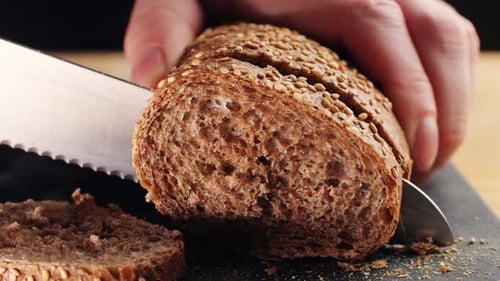 Slicing Sesame Seed Bread Loaf with Knife