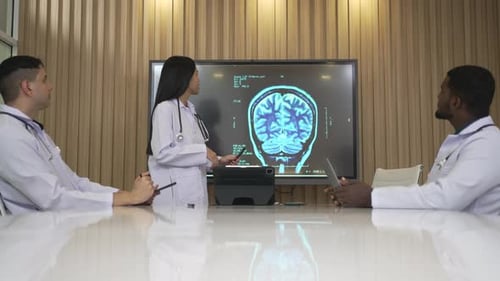 Medical Team Discuss Brain Scan in Modern Office