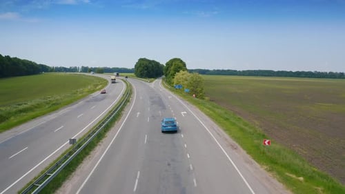 Blue modern car driving throw the road. Flight over the automobile driving.