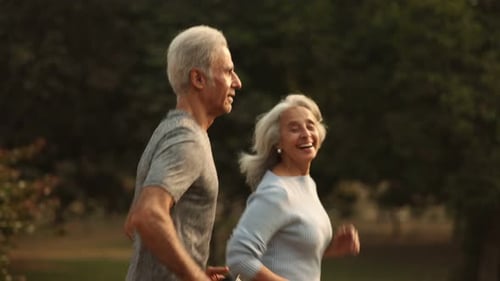 Elderly Couple Enjoying A Morning Jog in the Park