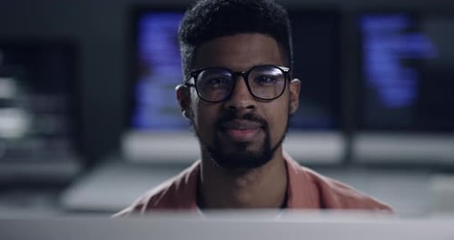 Smiling Man at Computer in Office