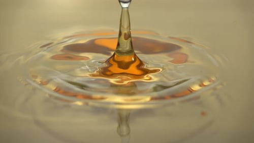 Amber Liquid Droplet Making Crown-Shaped Splash