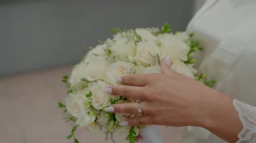Close up of Bride's Hand Touching Bouquet