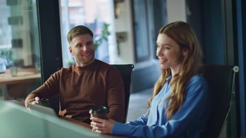 Two Colleagues Holding Coffee at Office Enjoying Friendly Communication Closeup