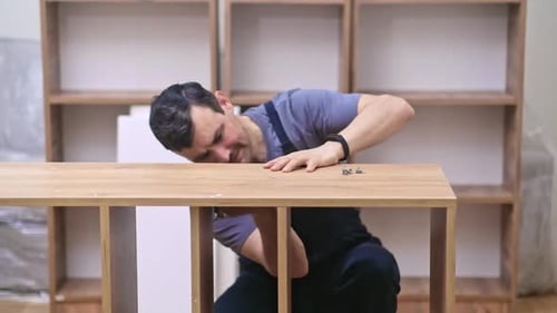 Man Assembling Shelving Unit Indoors