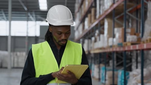 Warehouse Worker Checking Inventory Using Digital Tablet in Slow Motion