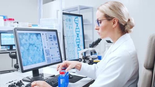 Female Scientist Analyzing Data in a Bright Lab